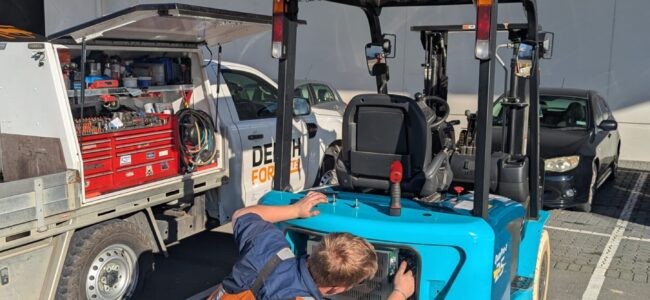 Electric forklift maintenance being carried out by a Dench Forklifts technician.